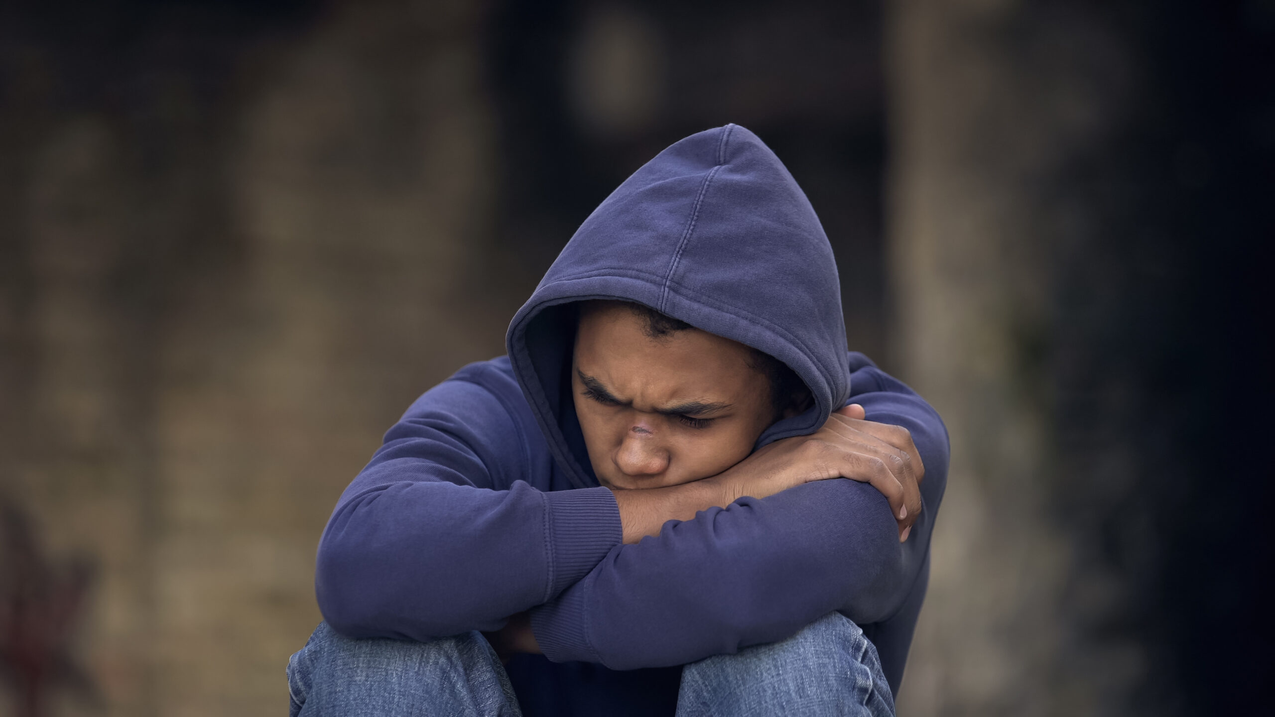 Desperate young man sitting street alone, domestic violence, running ...