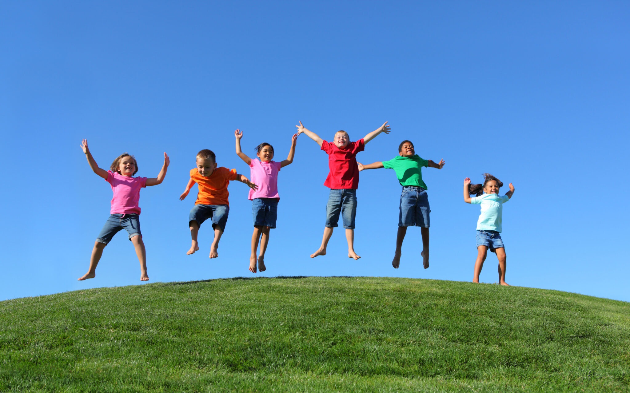 Group of multi-ethnic kids jumping together - Edgewood Center for ...